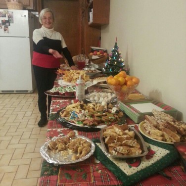 Christmas Eve is one of the most significant days throughout the holidays in the Italian culture. Here's my grandmother showing off our cookies.