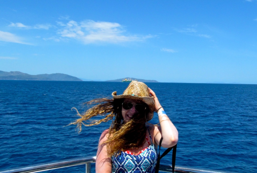 I stand for a windy boat ride photo while making my way out to the Great Barrier Reef. Photo by: Leviana Coccia.